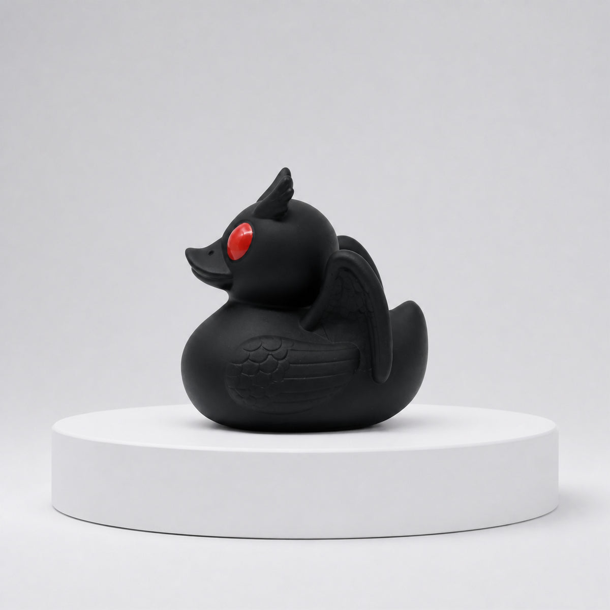 Rubber Duck
Side view of the Black Bill Mothduck, a Mothman-inspired rubber duck with a black body, red eyes, horns and wings.
