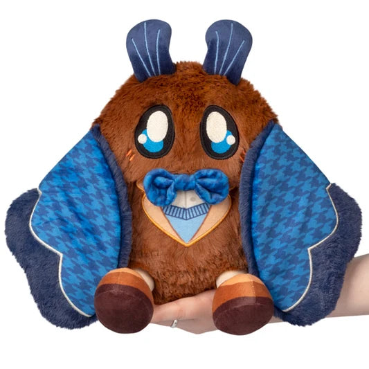 Front view of the Mini Cute Academia Mothman Squishable with brown plush body, blue houndstooth wings, bow tie, large eyes and academic-inspired details.
