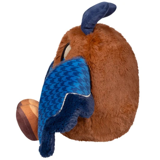 Side view of the brown Mothman plush showing its soft rounded body, blue patterned wing, antenna and foot details.